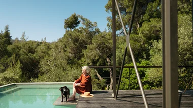 Older woman with her dog by pool