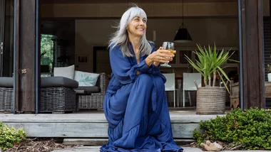 Woman in blue dress sitting on deck