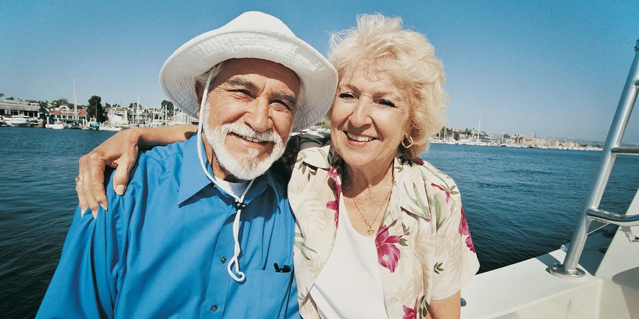 Retired couple smiling on a boat
