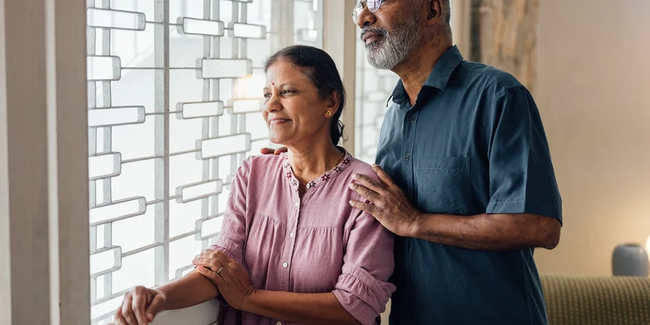 Retired couple looking out a window