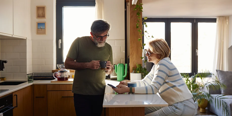 Couple looking at a phone in the kitchen