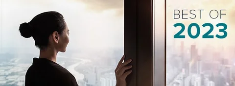 Woman looking out an office window.