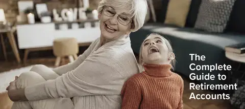 Grandmother and grandchild laugh together in living room.