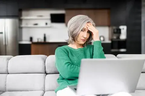 Widowed client gathers financial documents on laptop